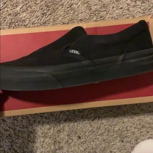 All black Vans slip ons
